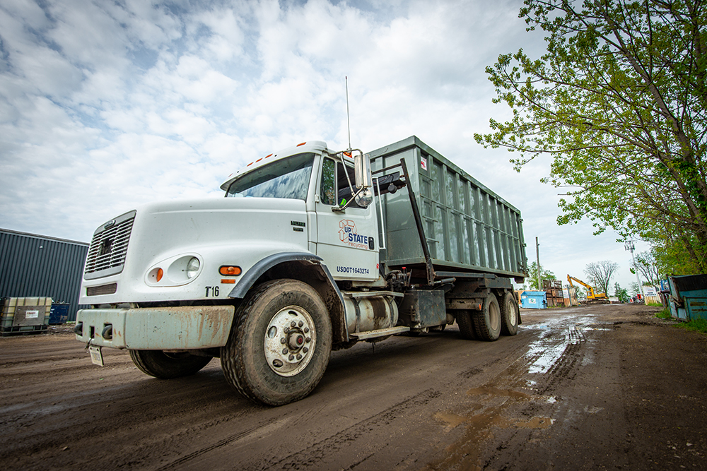 Roll-off Truck Service We are equipped with several roll-off and day cab tractors if your project requires scrap containers.
